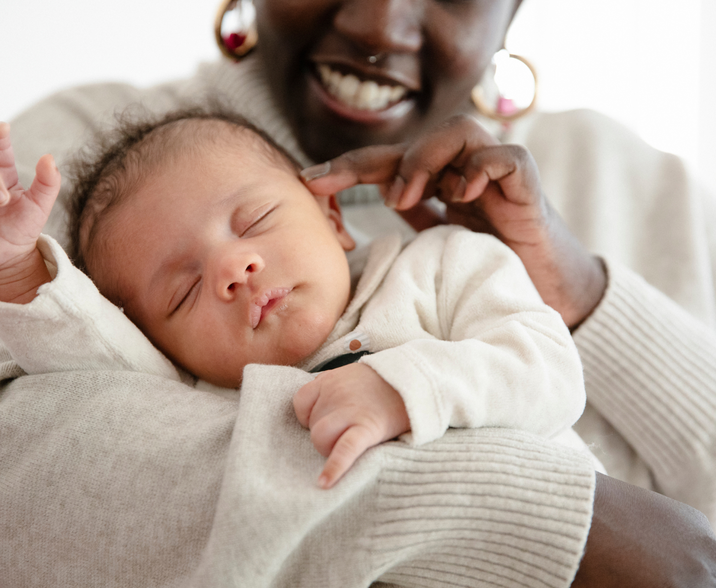 A tender moment between a mother and her sleeping baby.